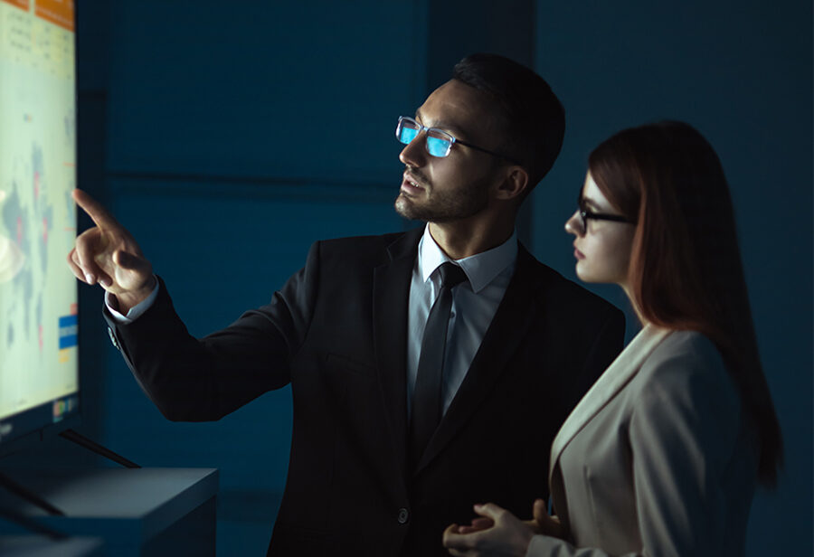 A man and a woman discussing a chart